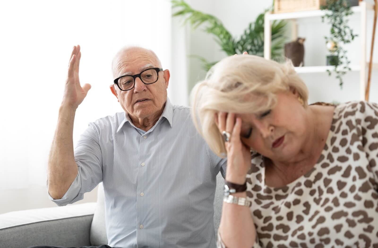 An older adult shouts and gestures angrily at their exhausted partner.